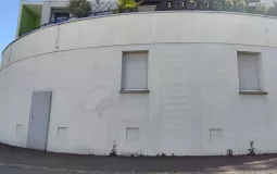 Photo montrant le mur du 13 rue Antonio Vivaldi, avant la réalisation de la fresque murale. Il est alors peint en blanc et dépourvu d'ornements.